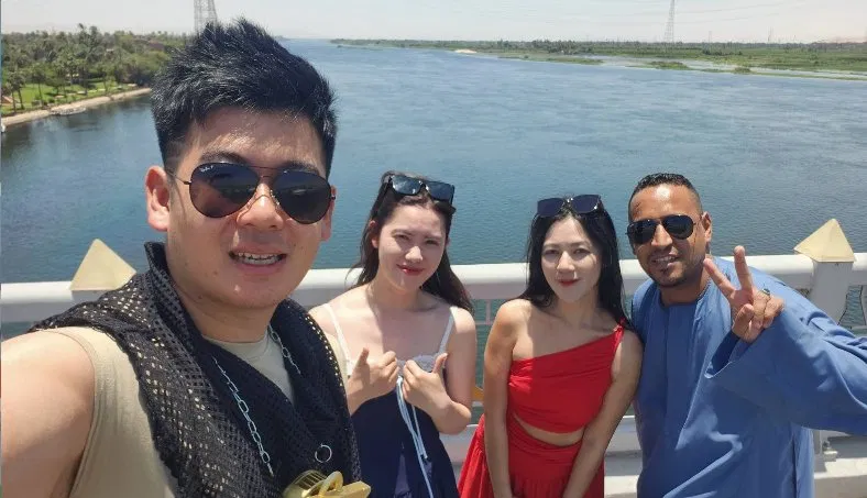 Travellers enjoying a sunny day on Luxor Bridge