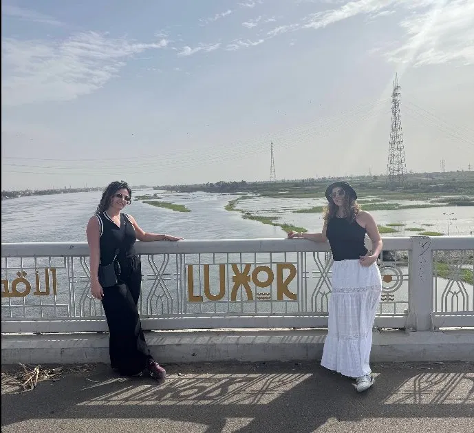 Happy travellers posing on Luxor Bridge over the Nile